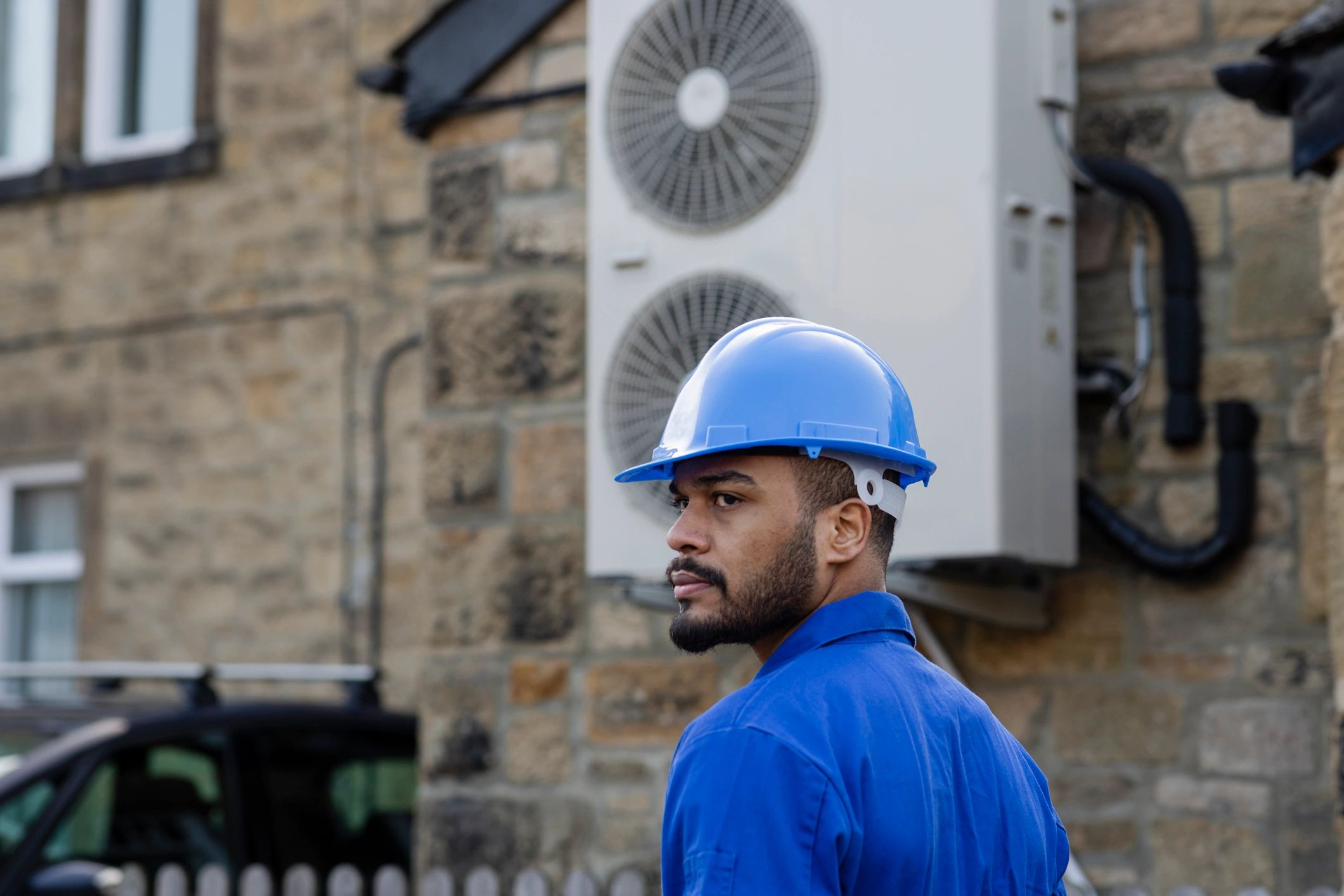 HVAC technician standing beside a home comfort system